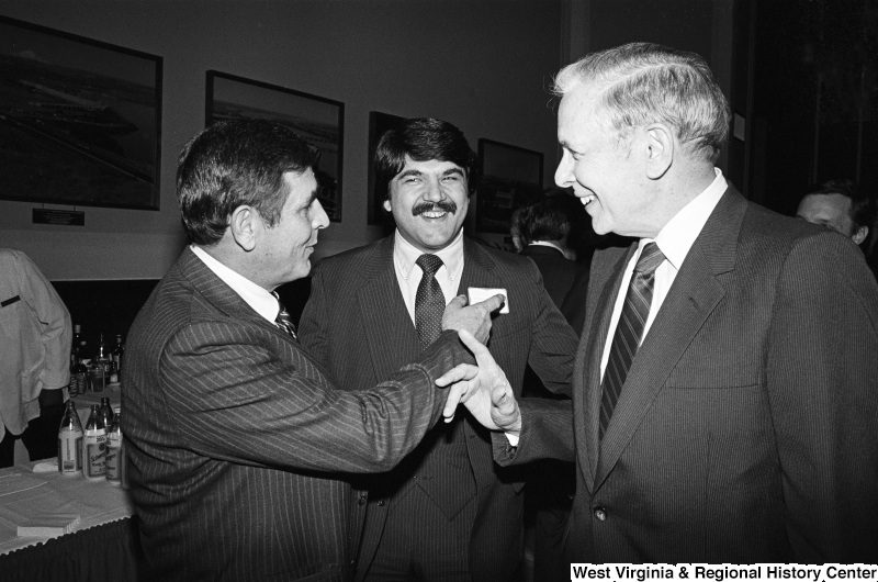 Photograph of Congressman Tom Bevill (AL), Richard Trumka, and an unidentified person at an event