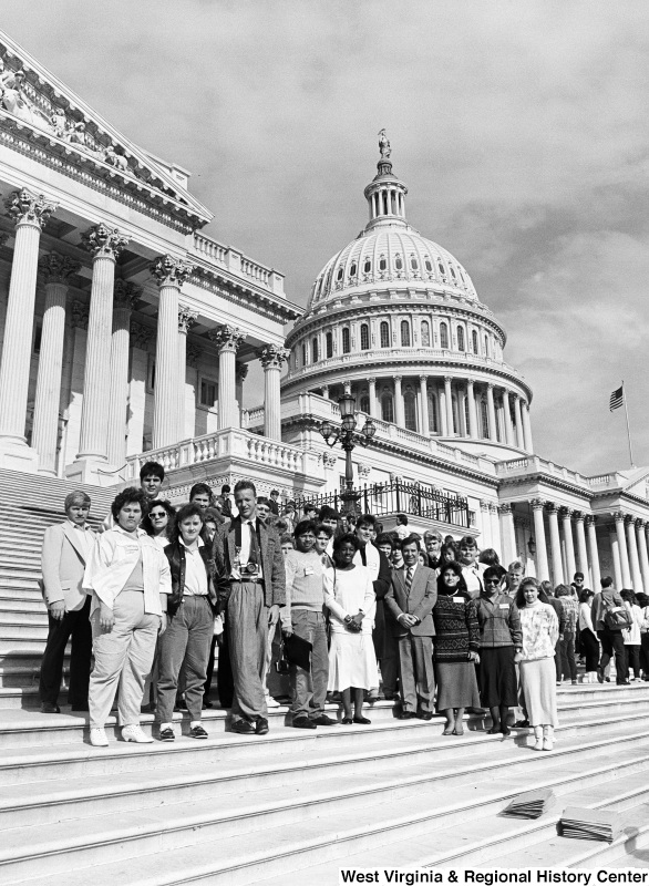 Photograph of Representative Nick Rahall with a group of unidentified people on the steps of the Capitol Building