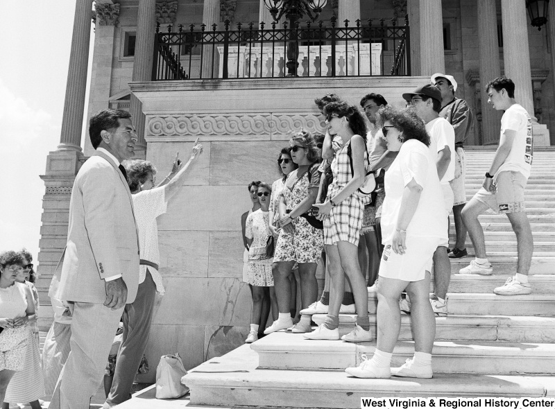 Photograph of Congressman Nick J. Rahall with an unidentified group on the Capitol steps