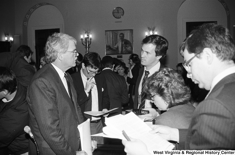 Photograph of Congressman George Miller speaking with an unidentified person