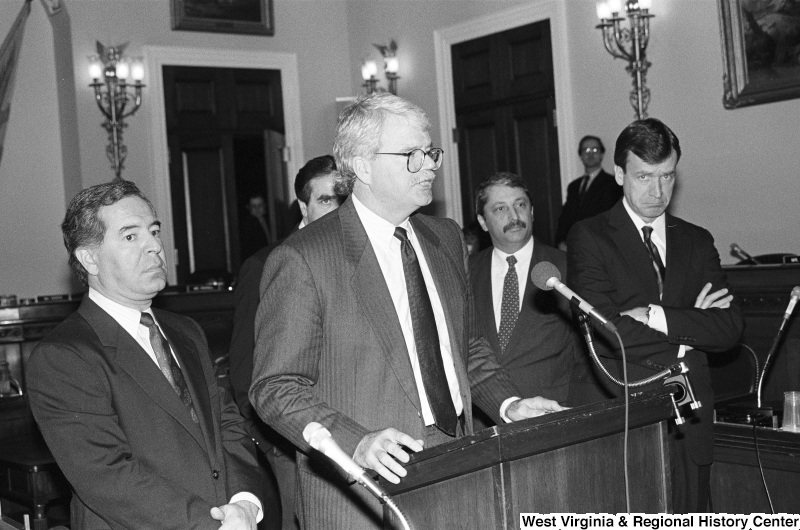 Photograph of Congressmen George Miller, Nick Rahall, Sam Gejdenson, and Peter Kostmayer speaking at an event