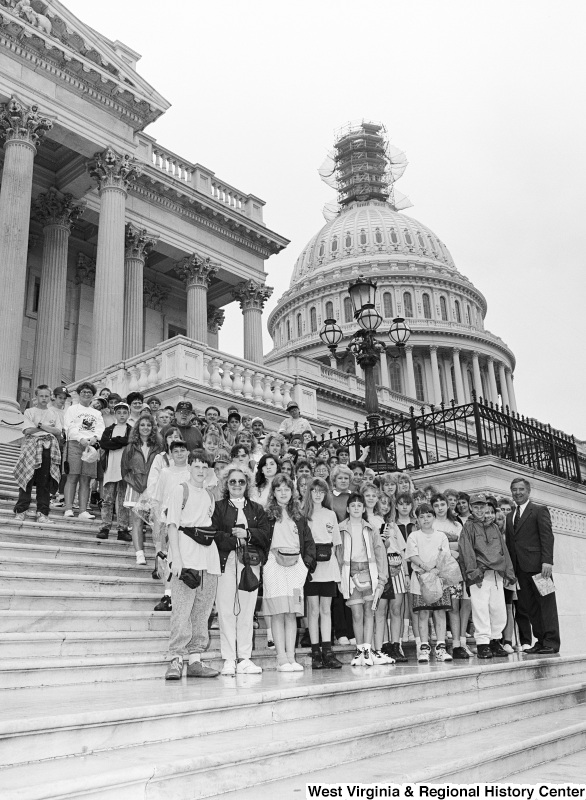 Photograph of Congressman Nick J. Rahall with an unidentified school(?) group on the Capitol steps