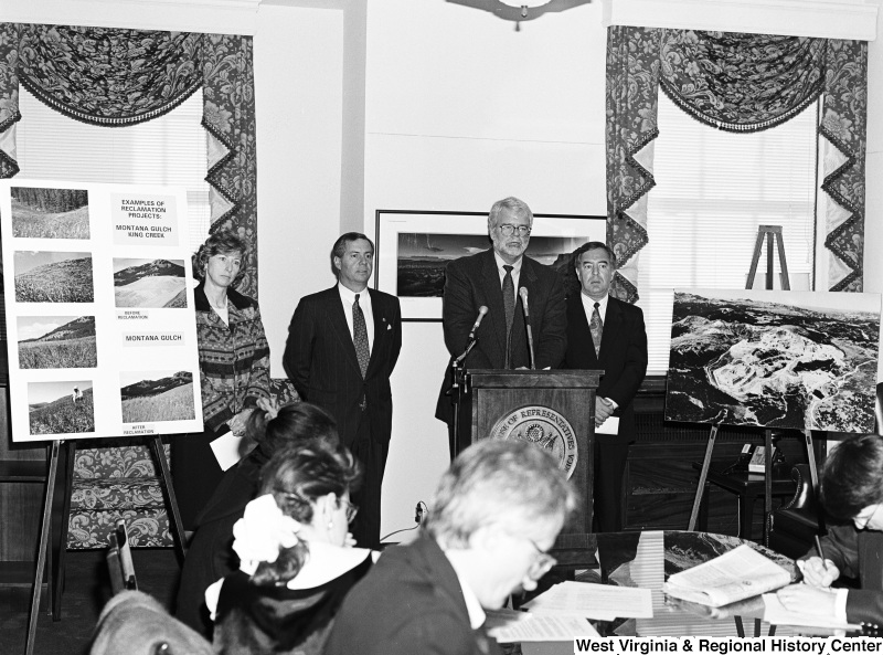 Photograph of Congressmen Nick Rahall and George Miller speaking at an unidentified press conference