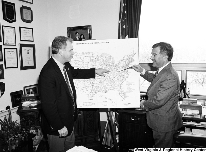 Photograph of Congressman Nick Rahall and an unidentified person discussing the proposed national highway system