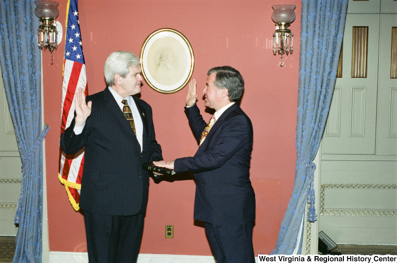 Photograph of Speaker of the House Newt Gingrich and Congressman Nick Rahall at a swearing-in ceremony