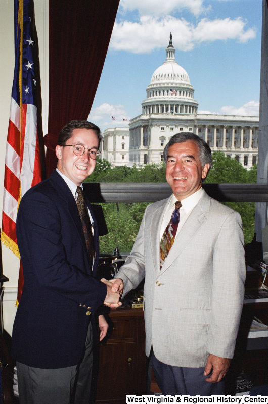 Photograph of Congressman Nick J. Rahall posing with an unidentified man in his office