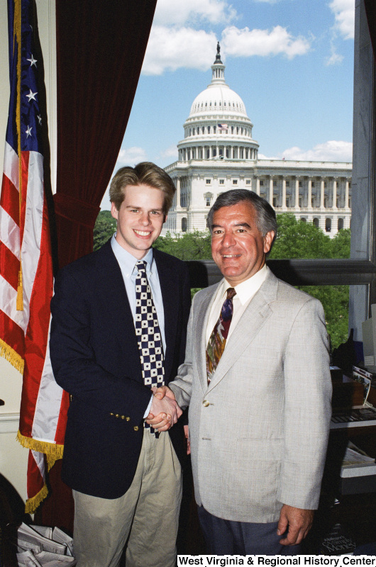 Photograph of Congressman Nick J. Rahall posing in his office with an unidentified visitor