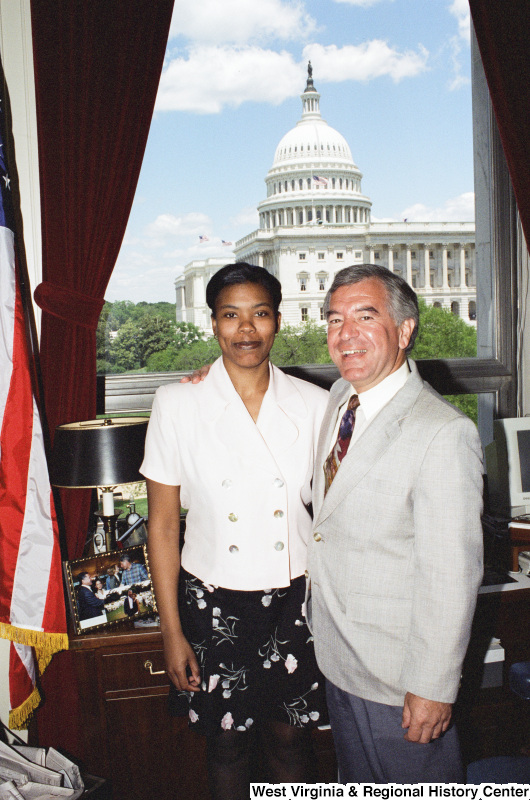 Photograph of an unidentified female visitor posing with Congressman Nick Rahall