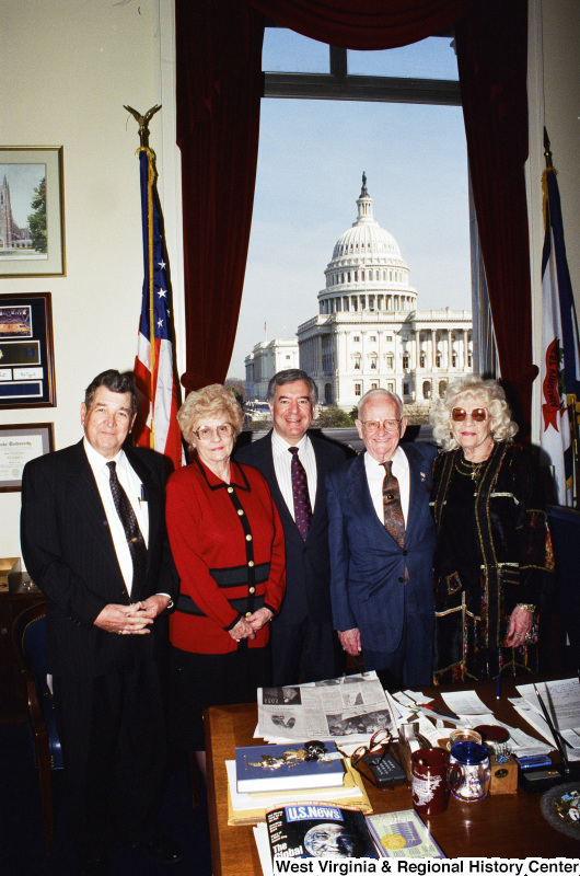 Photograph of Congressman Nick J. Rahall posing in his office with a group of unknown people