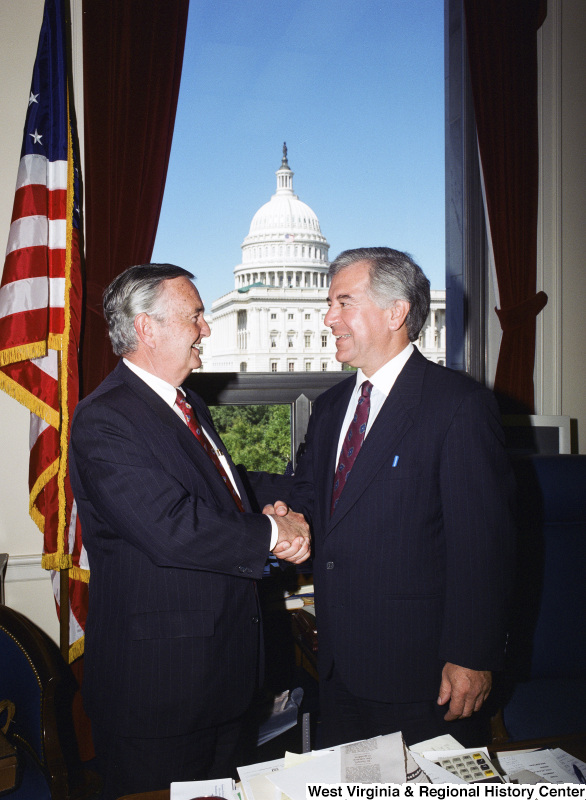 Photograph of Congressman Nick Rahall shaking hands with an unidentified man in his Washington, D.C. office