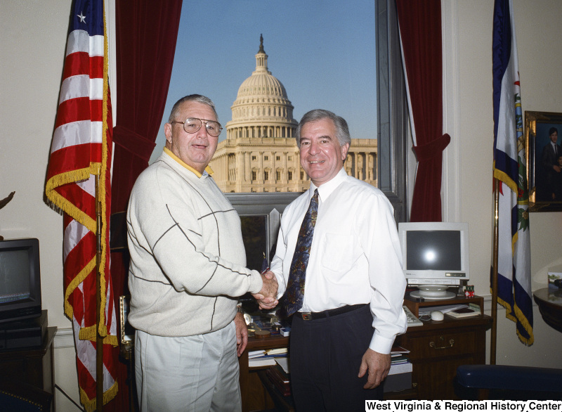 Photograph of Congressman Nick Rahall shaking hands with an unidentified visitor