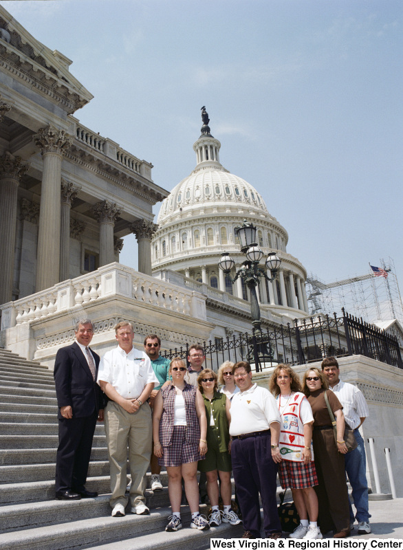 Photograph of a group of unidentified people visiting with Congressman Nick Rahall