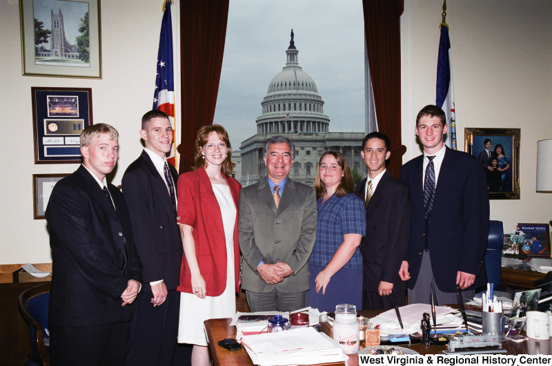 Photograph of Congressman Nick Rahall in his Washington office with an unknown group of young professionals