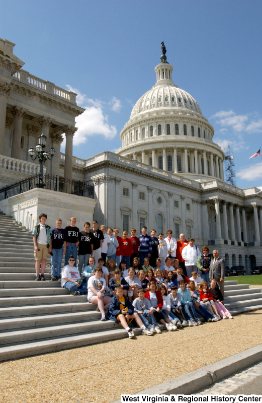 Congressman Rahall stands with children and other adults on the steps of the Capitol Building.