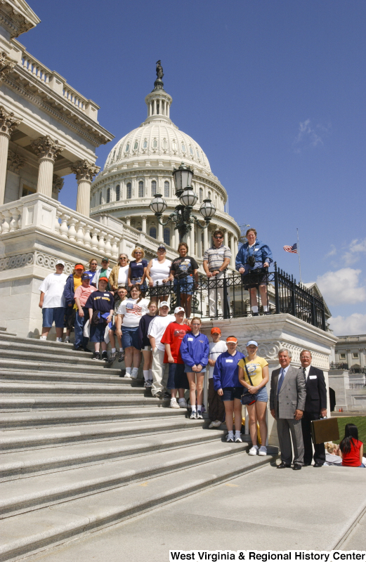 Congressman Rahall stands with some children and other adults on the steps of the Capitol Building.