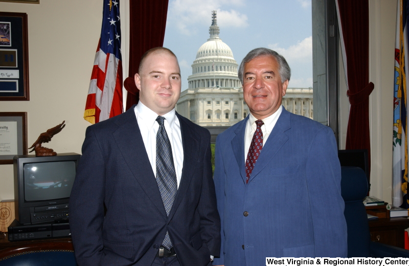 Congressman Rahall standing with an unidentified man in his Washington office.