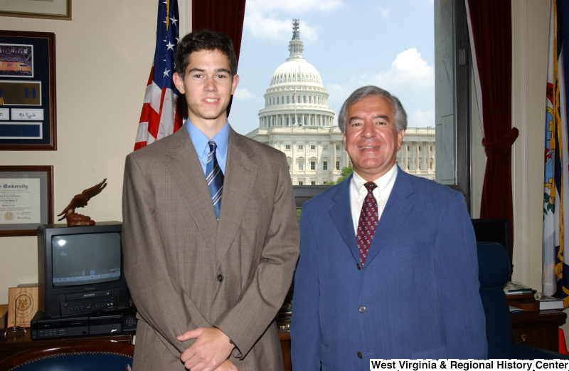 Congressman Rahall stands with a man wearing a taupe suit in his Washington office.