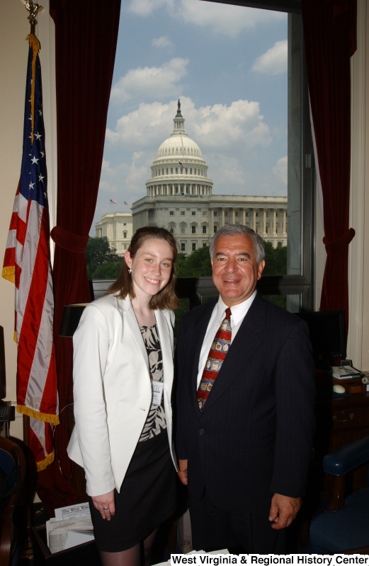 Congressman Rahall stands with a woman wearing a white sportcoat in his Washington office.