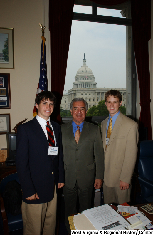 Congressman Rahall stands with two men wearing NYLC badges in his Washington office.