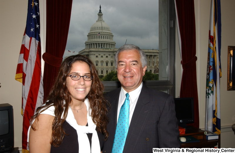 Congressman Rahall stands with a woman wearing glasses in his Washington office.