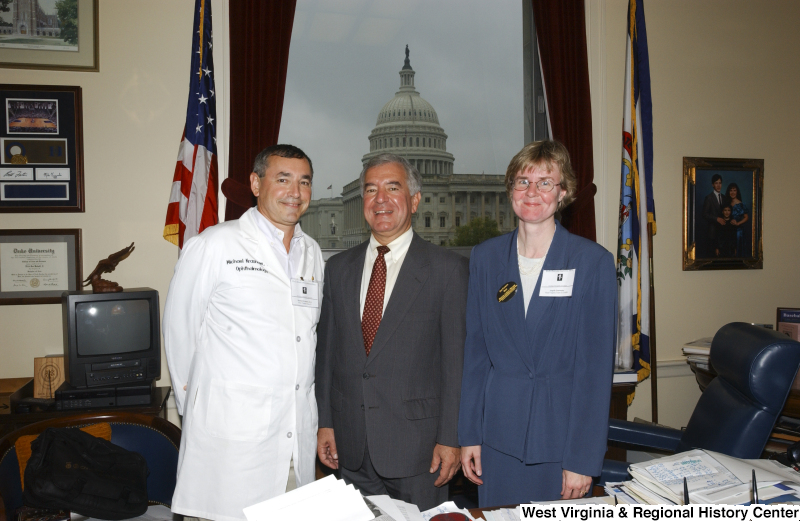 Congressman Rahall stands in his Washington office with Michael Krasnow, Doctor of Ophtalmology, and an unidentified woman.