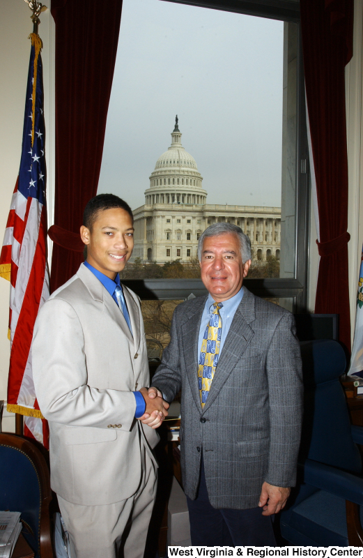 Congressman Rahall stands in his Washington office with a man wearing a light grey suit.