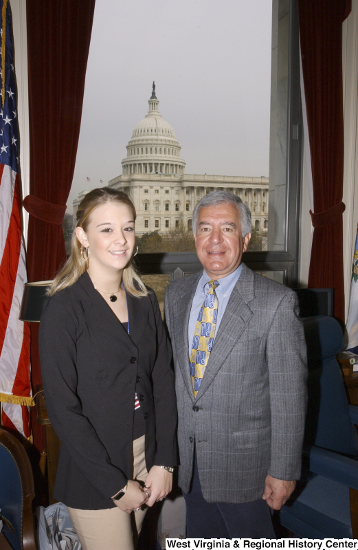 Congressman Rahall stands in his Washington office with a young woman.