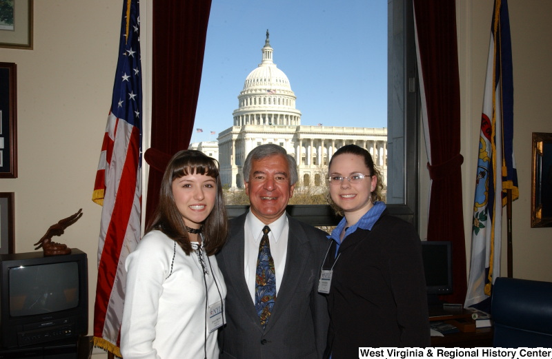 Congressman Rahall stands in his Washington office with two women wearing NYLC badges.