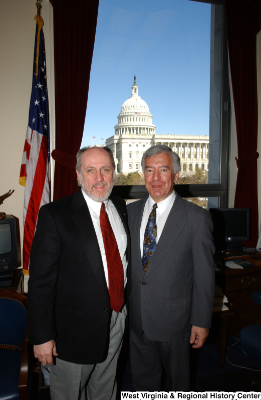 Congressman Rahall stands with an unidentified man in his Washington office.