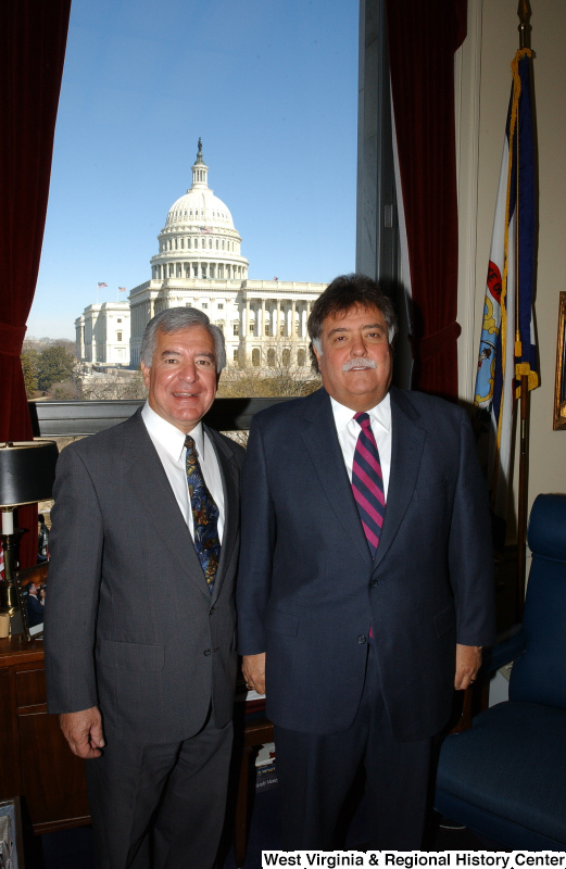 Congressman Rahall stands in his Washington office with a man wearing a dark suit and striped tie.