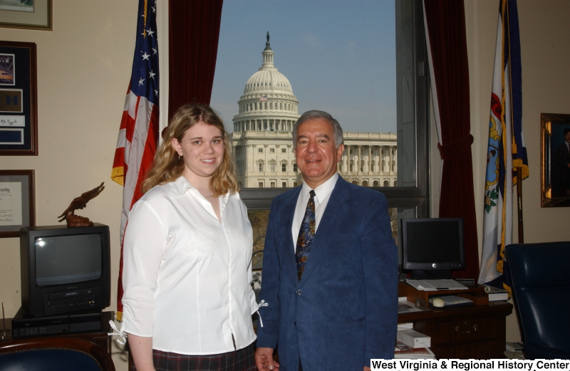 Congressman Rahall stands in his Washington office with a woman wearing a white blouse.