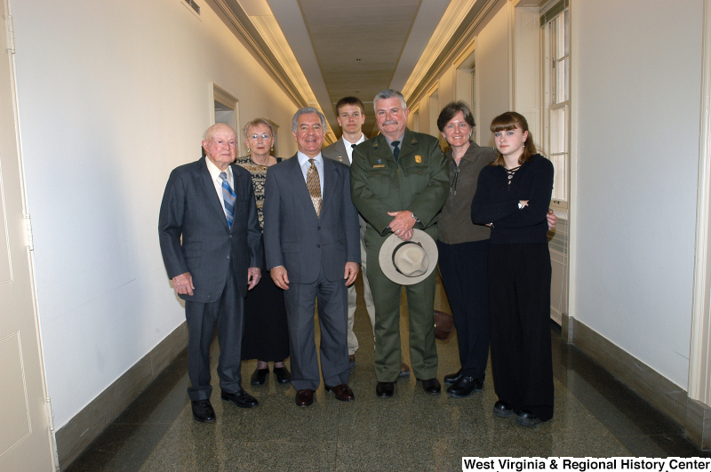 Photograph of Congressman Rahall standing in a hallway with a man from the Park Service and five other people