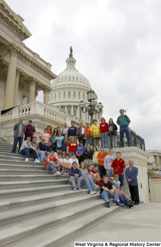 Congressman Rahall stands with a group of children and adults on the steps of the Capitol Building.