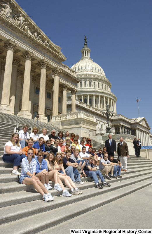 Congressman Rahall stands near a group of children and adults on the steps of the Capitol Building.