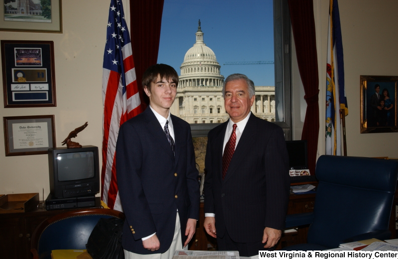 Congressman Rahall stands in his Washington office with a young man wearing a blue blazer.