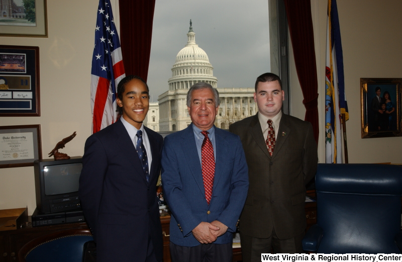 Congressman Rahall stands in his Washington office with two young men.