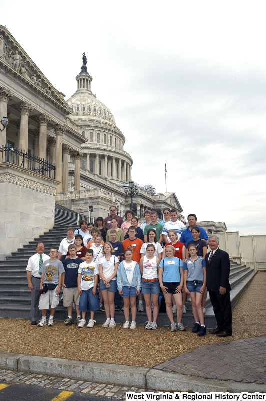 Congressman Rahall stands on the steps of the Capitol Building with a group of children and adults.