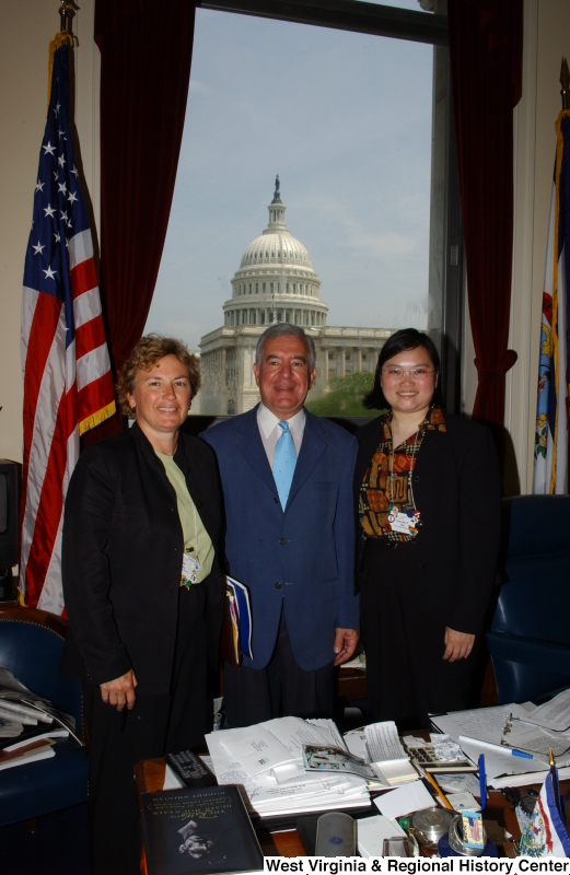 Congressman Rahall stands in his Washington office with two women.