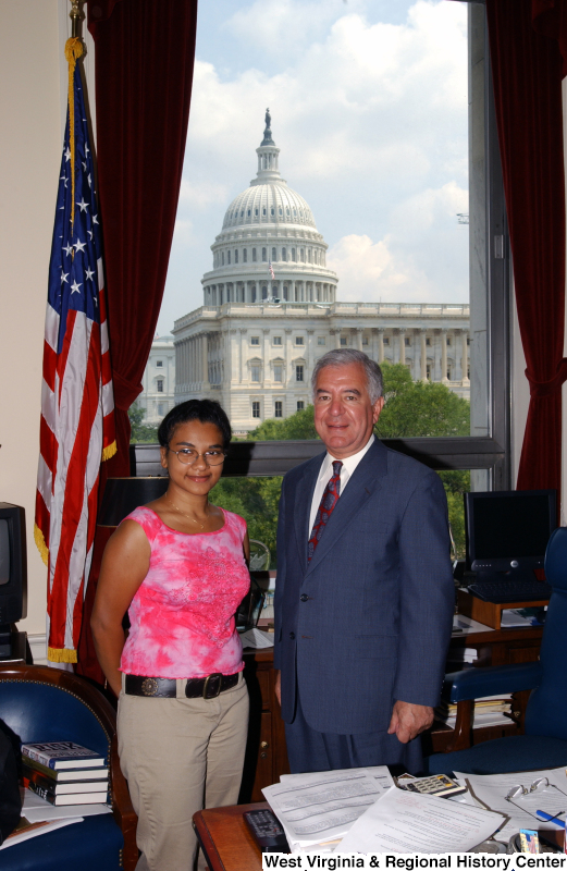 Congressman Rahall stands in his Washington office with a woman wearing a pink shirt.