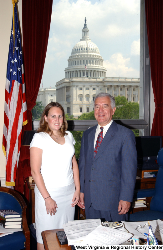 Congressman Rahall stands in his Washington office with a woman wearing a white shirt.