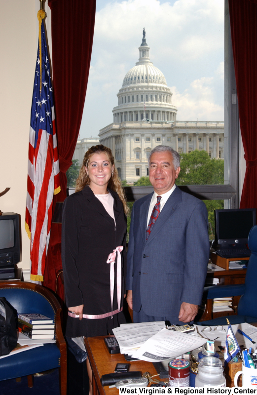 Congressman Rahall stands in his Washington office with a woman wearing a pink ribbon.