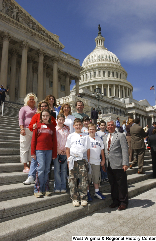 Congressman Rahall stands on the steps of the Capitol Building with children and adults.