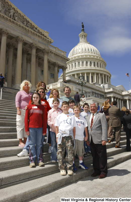 Congressman Rahall stands on the steps of the Capitol Building with six children and five adults.