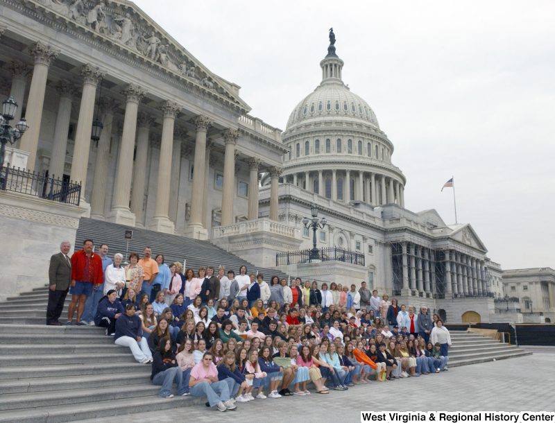 Congressman Rahall stands on the steps of the Capitol Building with a large group of children and adults.