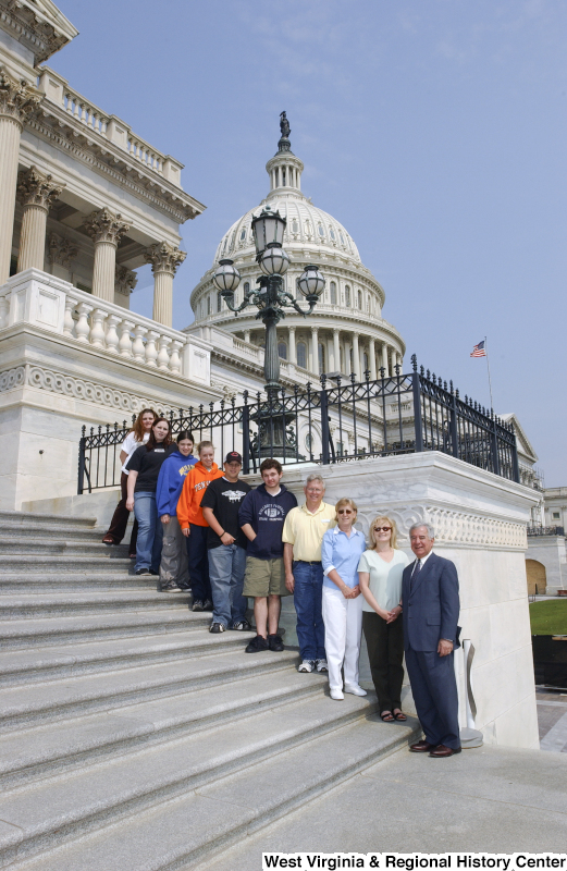 Congressman Rahall stands on the steps of the Capitol Building with nine children and adults.