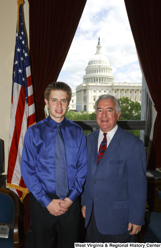 Congressman Rahall stands in his Washington office with a young man wearing a blue shirt.