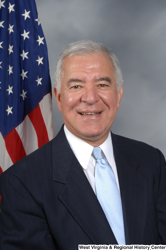 Congressman Rahall poses in front of the United States flag.