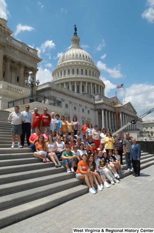 Congressman Rahall stands on the steps of the Capitol Building with children and adults.
