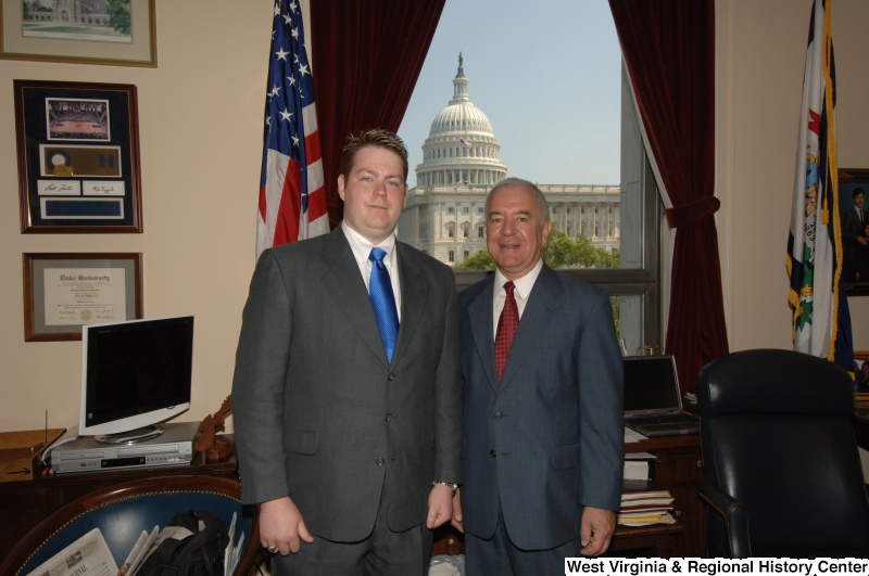 Photograph of Congressman Rahall in his Washington office standing with a man wearing a grey suit and blue tie