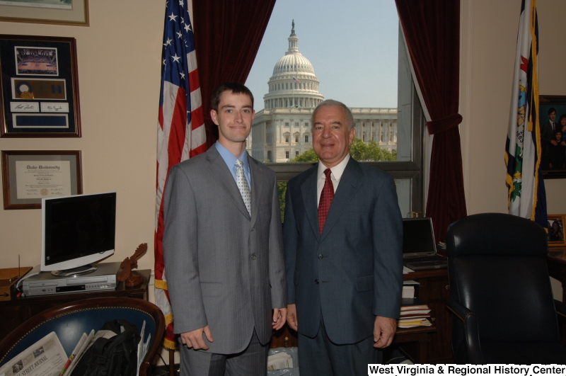 Photograph of Congressman Rahall in his Washington office standing with a man wearing a grey suit and silver tie